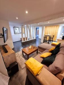 a living room with a couch and a table at Romantique room St Michel de Lanes (love room) in Saint-Michel-de-Lanès