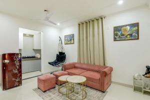 a living room with a couch and a table at Premium 2bhk near Airport, Manipal Hospital, Venkatesh Hospital and Yashobhoomi Convention Centre in New Delhi