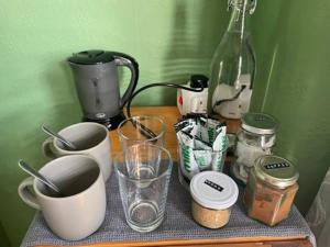 a table with cups and other kitchen items on it at Seaside Villa on Secluded Green in Kent