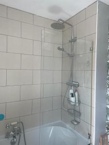 a bathroom with a shower with a bath tub at Seaside Villa on Secluded Green in Kent