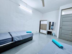 a bedroom with a bed and a door and a rug at PANCHOR 6 HOSTEL in George Town