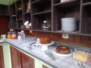 a kitchen with a counter top with food on it at Pousada Sol e Lua in Caraguatatuba
