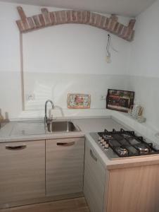 cocina con fregadero y fogones horno superior en CASA DEL CORSO, en Dorgali