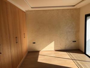 an empty room with a door and a wall at La Fondation in El Harhoura +34 photos