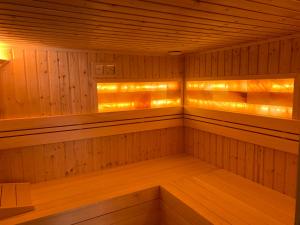 a sauna with wood paneling and lights at Ady13 Vendégház Eger in Eger