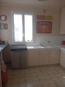a kitchen with a sink and a window at Le Vintage 14 in Bayeux