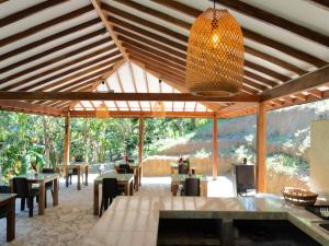 a pavilion with tables and chairs and a chandelier at Hukumeizi Minca in Santa Marta