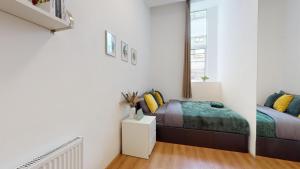 a white bedroom with a bed and a window at Small & Cosy 1 Bedroom Flat in London