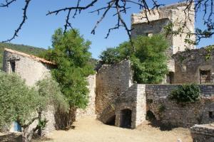 an old stone building with trees in the foreground at Studio lumineux « Judée » in Peyruis +12 photos