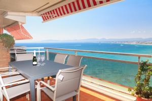 a table and chairs on a balcony with a view of the ocean at UHC Bahia Family Complex in Salou