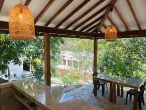 a dining room with a table and two lights at Hukumeizi Minca in Santa Marta