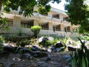 an apartment building with rocks in front of it at Hukumeizi Minca in Santa Marta
