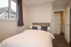 a bedroom with a bed and a window at 6, The Cuckmere in Seaford