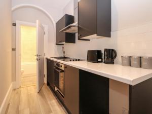 a kitchen with black and white cabinets and a counter top at 1 The Charleston in Seaford