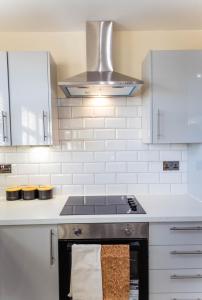 a kitchen with a stove and a sink at Two Bedroom Luxury RB Home in Stalybridge