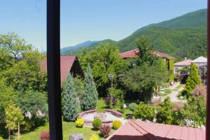 a view of a garden from a window at Royal Edena in Ambrolauri