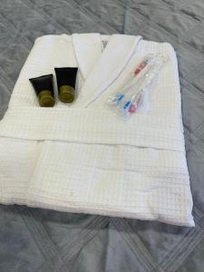 - une serviette blanche accompagnée de 2 bouteilles dans l'établissement 1-комнатная квартира Виноградова 12, à Öskemen