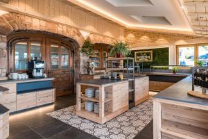 a large kitchen with wooden cabinets and a counter at Haus Weitblick by Spinnerhof in Sasbachwalden