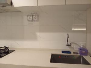 Cilenggangにあるapartemen sky house bsdのシンクとカウンタートップのあるキッチン