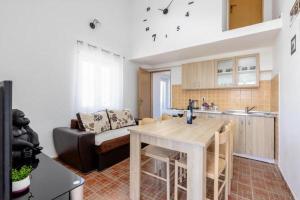 a kitchen and living room with a table and a couch at Apartments Ivo Bozinovic in Tivat