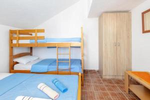 a bedroom with two bunk beds and a desk at Apartments Ivo Bozinovic in Tivat