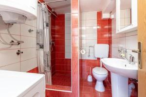 a bathroom with a toilet and a shower and a sink at Apartments Ivo Bozinovic in Tivat