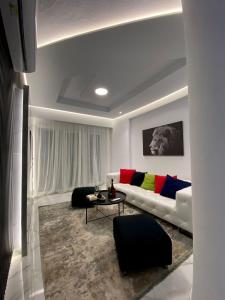 a living room with a couch and a table at Suncity Tirana Luxury Apartments (Ap. 01) in Tirana