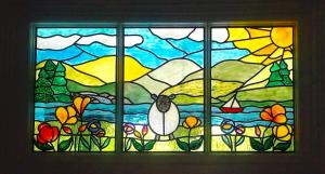 a stained glass window with a bird and flowers at Puddle Duck Lodge – Adults Only in Bowness-on-Windermere