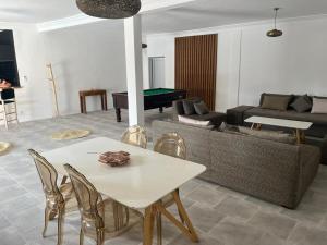 a living room with a table and a pool table at Villa B à 5km du centre in Marrakech