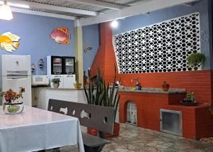 サクアレマにあるLugar de Ser Feliz Casa da Jôのキッチン(テーブル、レンガ造りの暖炉付)