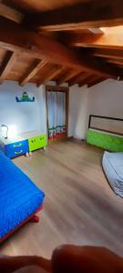 a large room with two beds in a room with wooden ceilings at Casa Porta dei Frati in Canepina