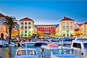 a group of boats docked in a harbor with buildings at Palace Inn Rooms in Split