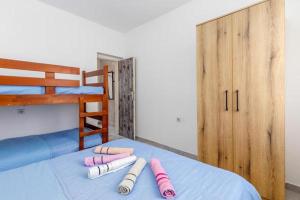 a room with a bed with four pillows on it at Apartments Ivo Bozinovic in Tivat