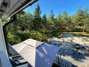 a tent on a porch with a grill and trees at Nordic Villa in Husum
