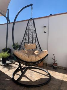 a swing chair hanging on a patio at Incanto in Sestu