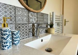 a bathroom with a sink and a mirror at Chalet Paisible proche du Lac in Biscarrosse +30 photos