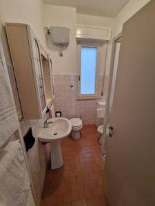 a bathroom with a sink and a toilet at Trilocale centrale e a due passi dal mare con posto auto privato in Marcelli +6 photos
