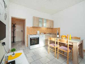 a kitchen with a table and a kitchen with a stove at Apartments Ivo Bozinovic in Tivat