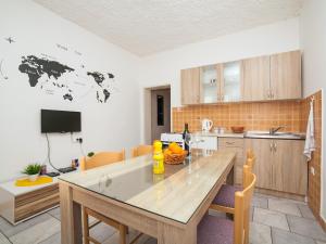 a kitchen with a large wooden table in a room at Apartments Ivo Bozinovic in Tivat