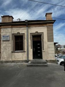 a building with a black door and two windows at 4х комнатная квартира Дом in Samarkand