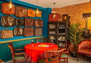 a dining room with a table and a bunch of bags on the wall at Chemodann Kazbegi in Stepantsminda