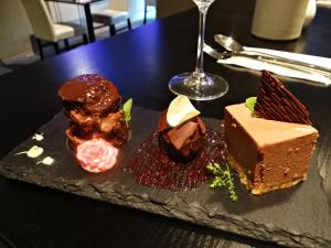 a plate with different types of desserts on a table at Hotel U Kříže in Prague