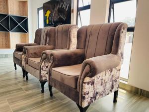 a row of chairs sitting in a room at Shafas Guest House in Rundu