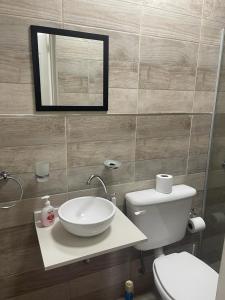 a bathroom with a sink and a toilet and a mirror at Espectacular Departamento en Vicente Lopez ,Avenida San Martín 2248 in Vicente López