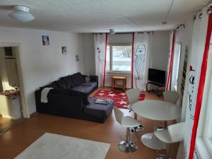 a living room with a couch and a table and chairs at Loviisan Limu in Lovisa