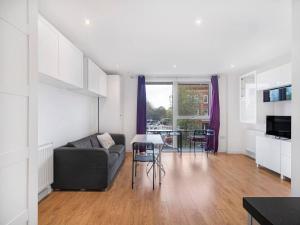 a living room with a couch and a table at Pass the Keys Spacious Apartment in Camberwell in London