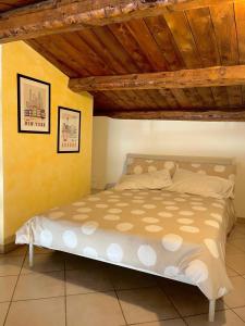 a bed in a bedroom with a wooden ceiling at La Casetta In Piazza in Sulmona