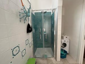 a shower with a glass door in a bathroom at Tabula Apartments in Olbia