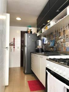 uma cozinha com um frigorífico e um fogão em Quarto super especial no Rio no Rio de Janeiro