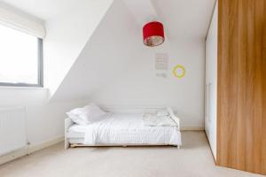 a white room with a bed and a window at Cosy Twin beds with parking and Smart TV in a great location in Bexleyheath